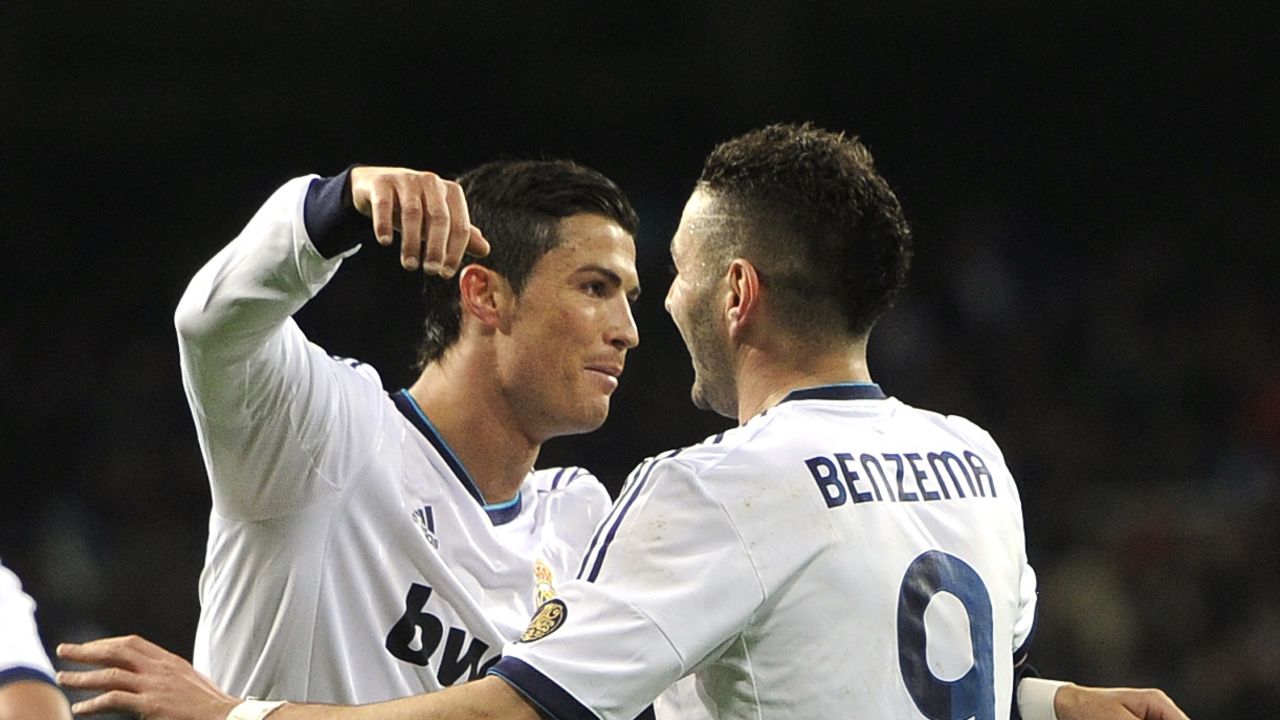 Cristiano Ronaldo (L) congratulates Karim Benzema after the French striker opened the scoring against Valencia