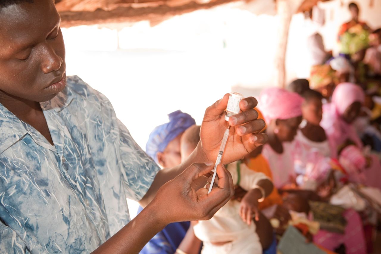 A nurse at an outreach clinic in The Gambia prepares a vaccination.