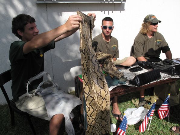 Chris Wood's (far right) family business All American Gator offered participants an opportunity to turn their catches into just about anything, even pants. The pair held in this photo cost $3,000. The company is also offering to pay for snake hides and is offering a bonus prize for the biggest skins.