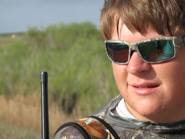 Coby Pawlowski surveys the land with a .22-caliber rifle on his shoulder. The 17-year-old is one of the youngest participants in the 2013 Python Challenge and is accompanied by his father Bob Pawlowski and his friend, 17-year-old Jimmy Harper.