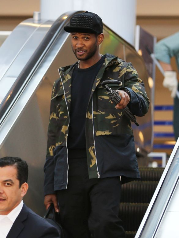 Usher arrives at the airport in Los Angeles.