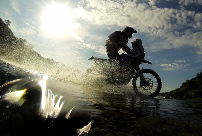 A biker competes rides through water on January 15.