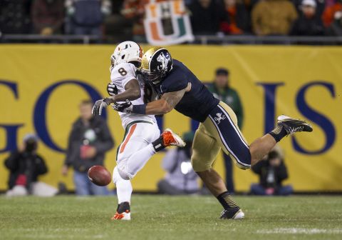 Te'o tackles Miami running back Duke Johnson during the Fighting Irish game against the Miami Hurricanes in Chicago on October 6. Notre Dame defeated Miami 41-3. 