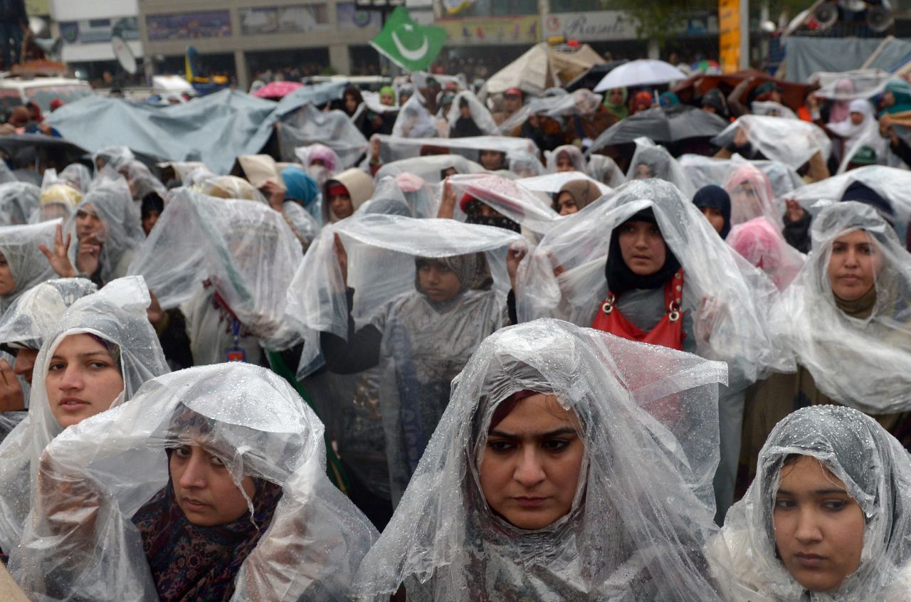 Supporters of Tahir-ul Qadri gather in the rain at a protest rally in Islamabad on January 17.