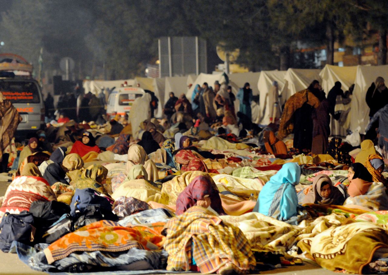 Protesters rest on the third day of the rally in Islamabad on January 16.