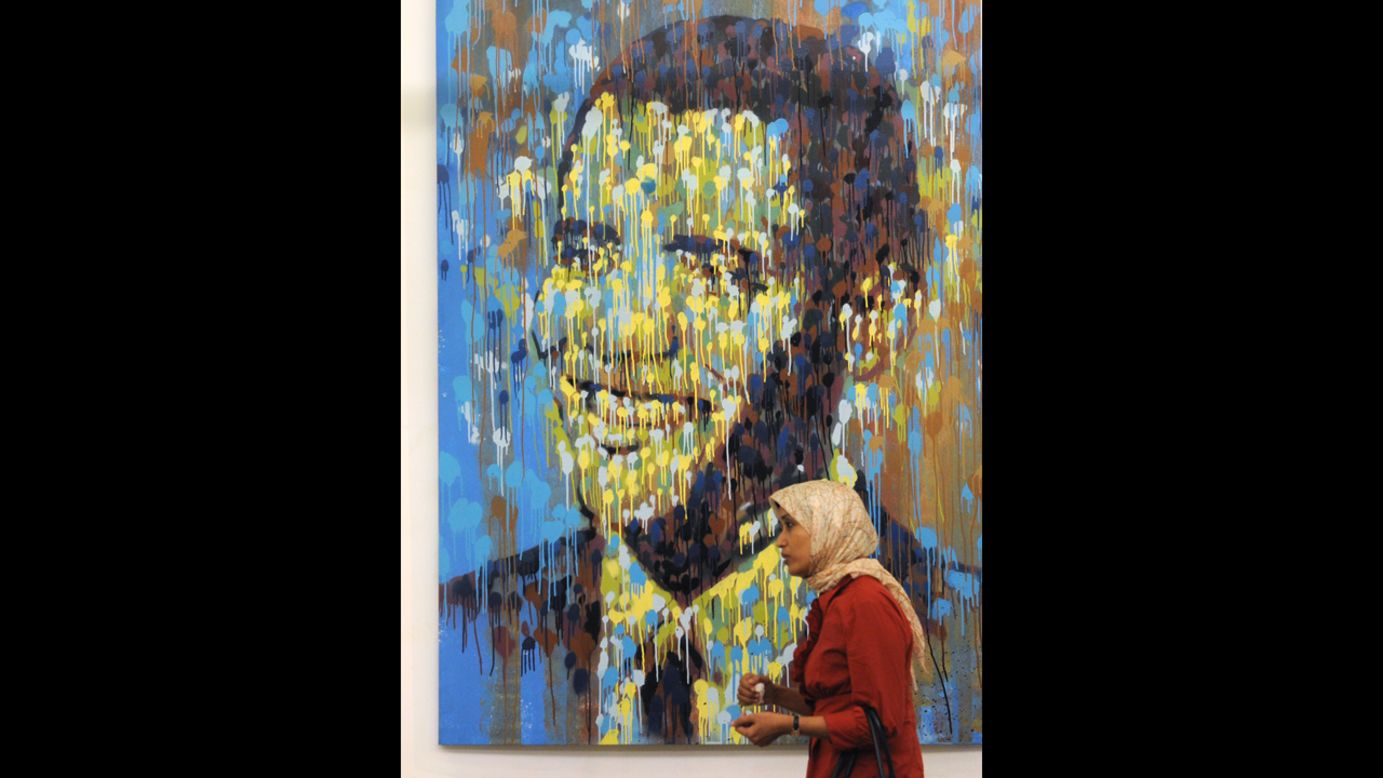 INDONESIA: A woman walks past a portrait of Obama at an exhibition in Jakarta, Indonesia, on July 30, 2010.