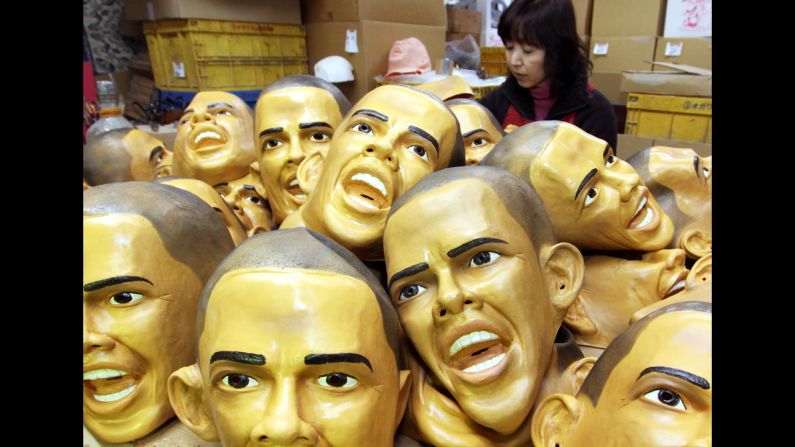 JAPAN: Fusako Moriya, an employee of Ogawa Studios Co. Ltd., paints an eye on a rubber mask of Obama at the company's factory in Saitama city, Japan, on January 20, 2009.