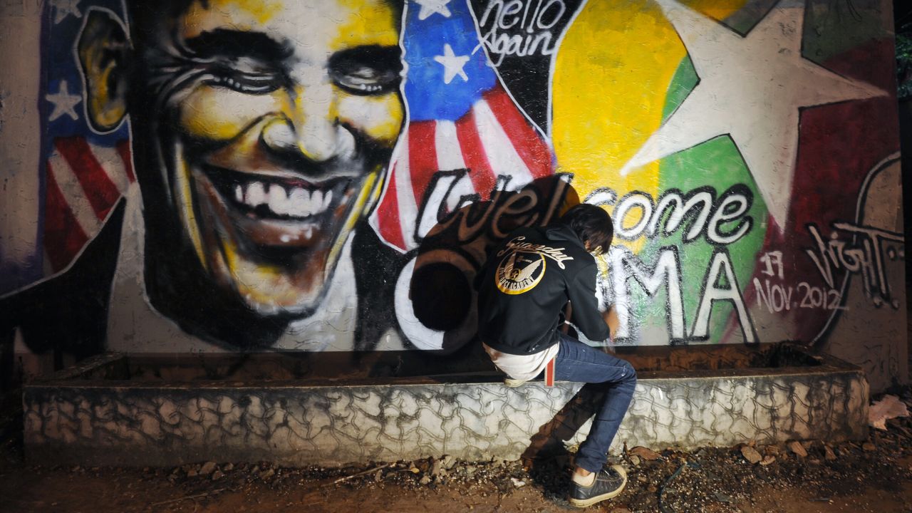 MYANMAR: Arkar Kyaw paints graffiti on a wall of Obama in Yangon on November 17, 2012.