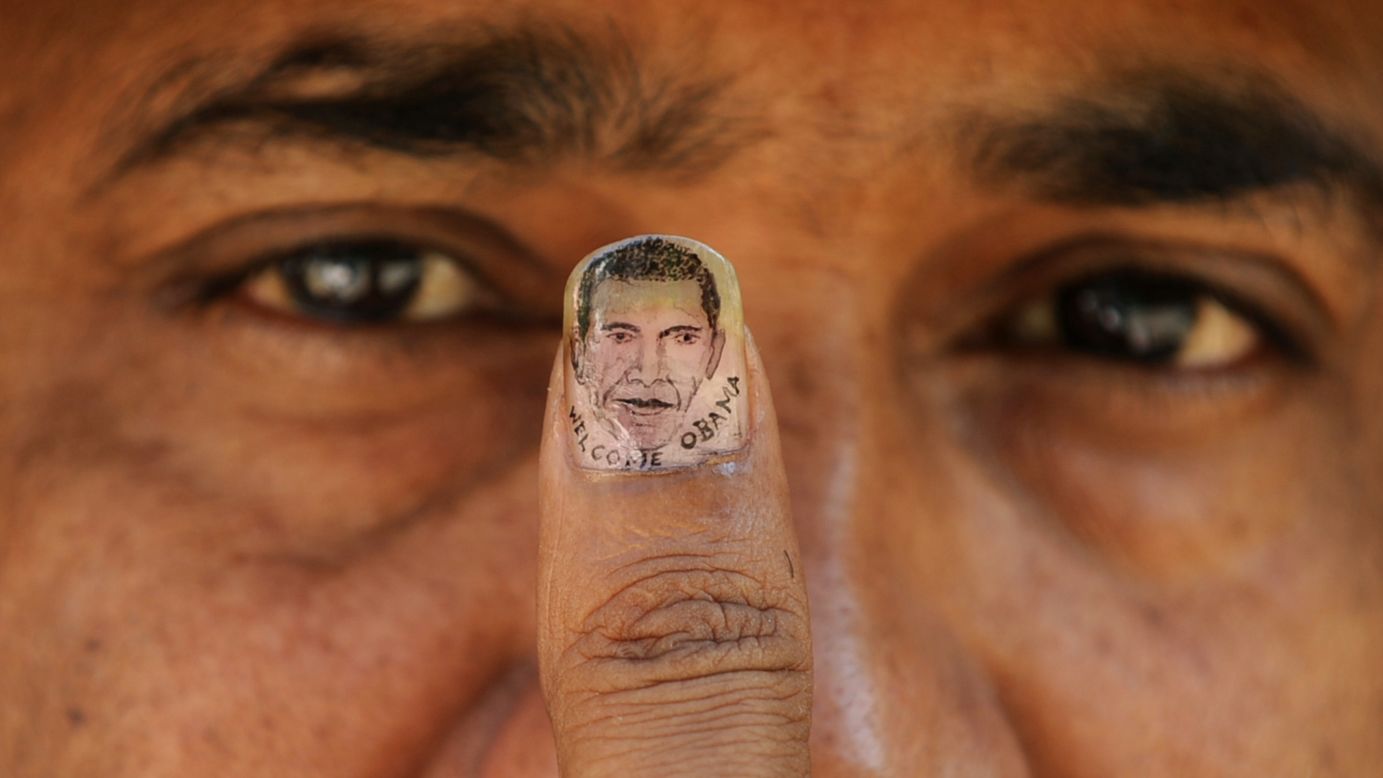 INDIA: Micro-artist Ramesh Sah shows the nail of his thumb painted with an image of Obama in Siliguri on November 6, 2010.