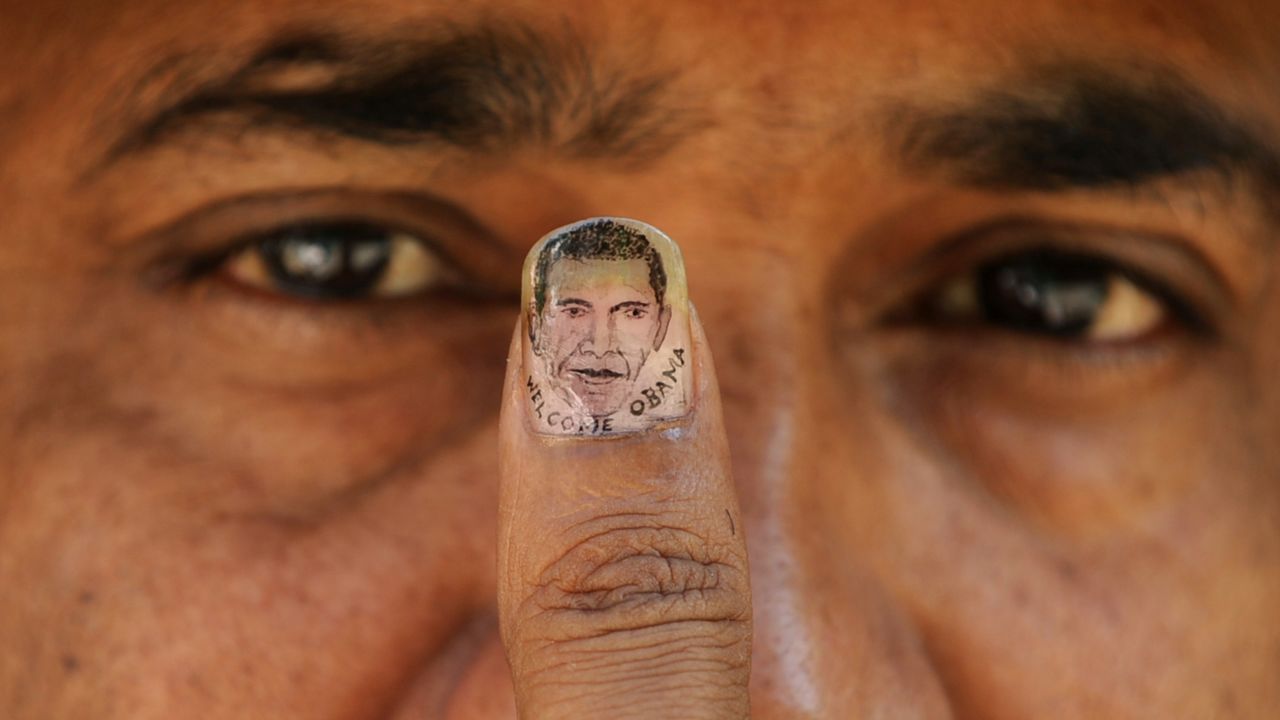INDIA: Micro-artist Ramesh Sah shows the nail of his thumb painted with an image of Obama in Siliguri on November 6, 2010.