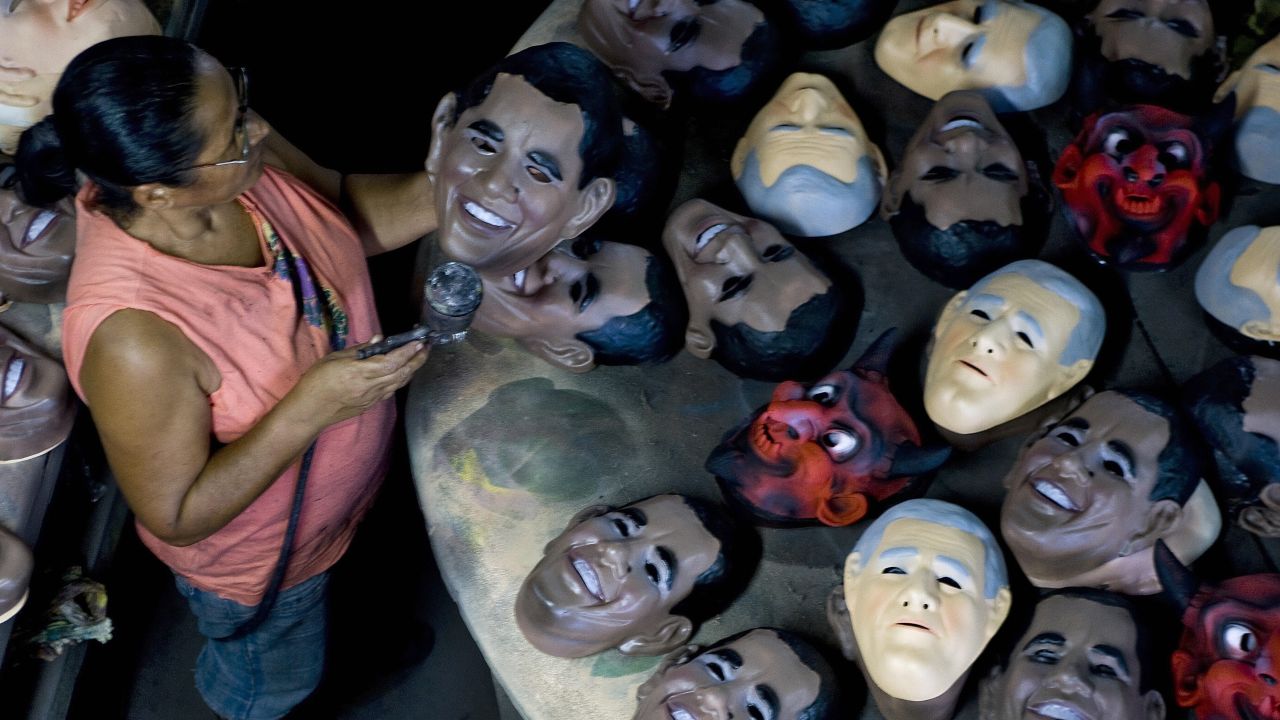 BRAZIL: A worker of the Condal Carnival Mask Factory inspects a mask portraying Obama in Sao Goncalo, on February 10, 2009.
