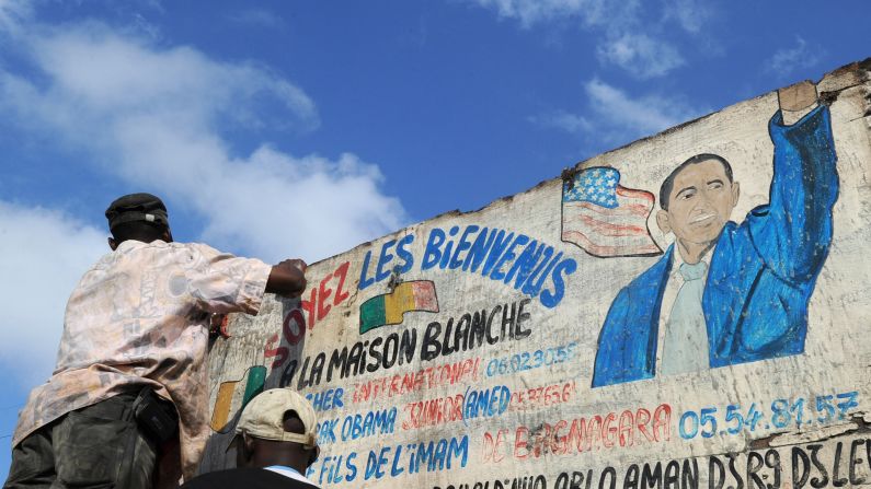 IVORY COAST: A man washes the sign of a butchery named "Maison Blanche" (White House) in Abidjan on November 7, 2012.