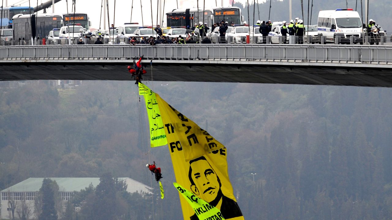TURKEY: Greenpeace activists open a banner depicting Obama on Bosphorus Bridge on April 6, 2009, in Istanbul.