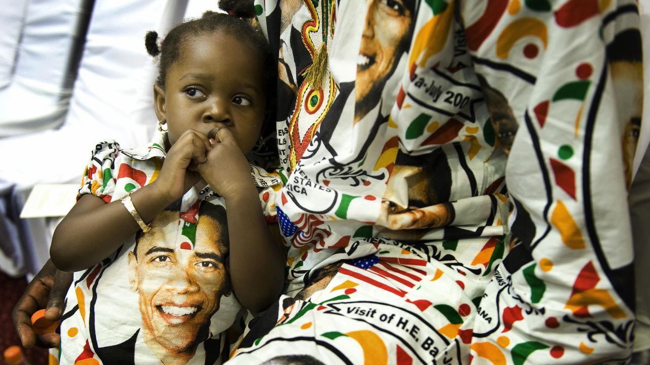 GHANA: Princess Smith, 2, sits with her father, Francis, on July 11, 2009, as they wait for Obama's arrival in Accra.