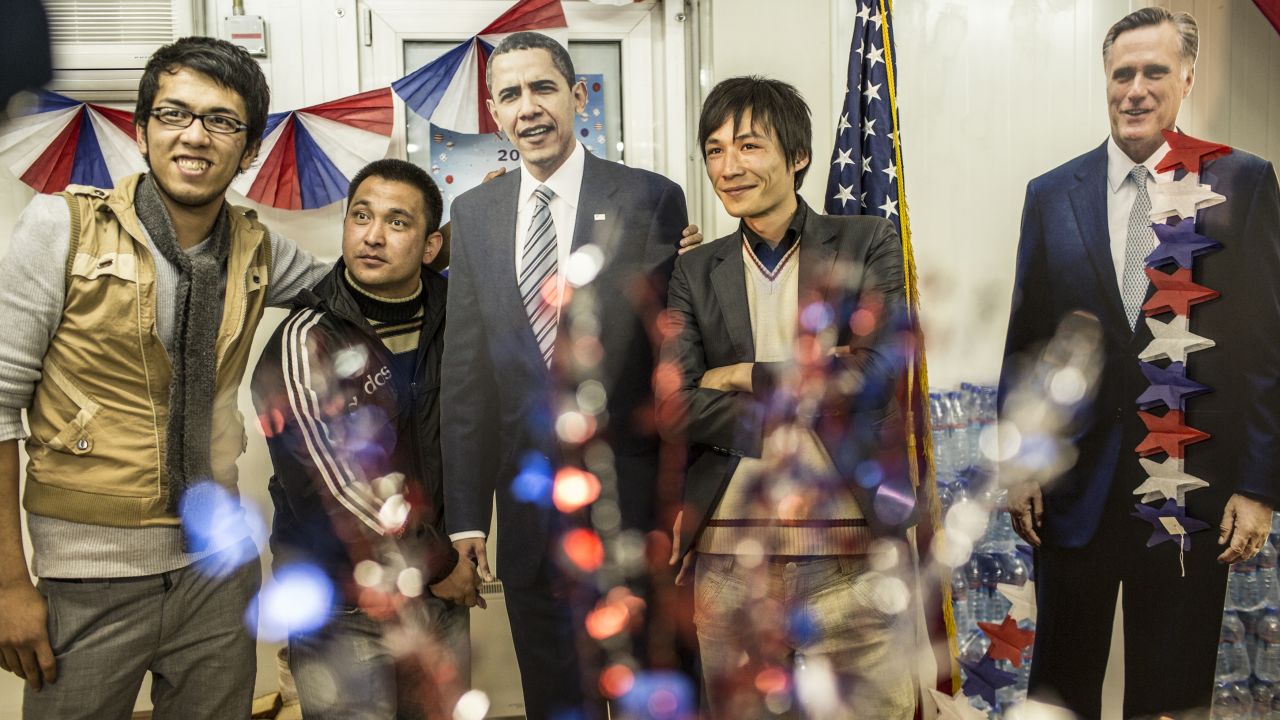 AFGHANISTAN: Afghan journalists pose with cardboard cutouts of Obama and Mitt Romney during an election event at the U.S. Embassy on November 7, 2012, in Kabul.