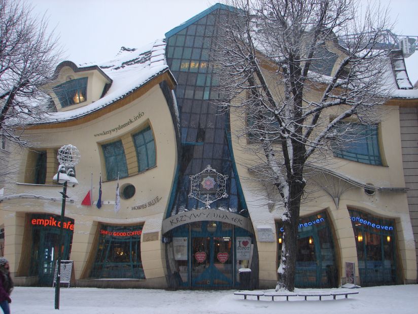 Known as the "Crooked House," this cartoon-like edifice houses a mall, restaurants and office buildings. <br /><br />Built in 2004 by the design team of Szotyńscy & Zaleski, this whimsical building is said to have been inspired by the work of two distinguished Polish artists, illustrator Jan Marcin Szancer and children's literature author Jan Brzechwa. <br /><br /><a href="http://krzywydomek.info/home-page.html" target="_blank" target="_blank">Krzywy Domek</a> has become so popular with visitors that an interior wall has been designated as a "wall of fame" where participants of cultural events are asked to autograph their names. 