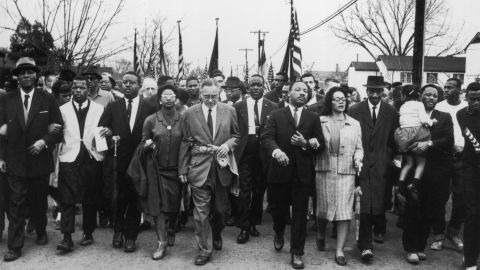Martin Luther King and his wife, Coretta King, lead a voting rights march from Selma to Montgomery, Alabama, in March 1965.