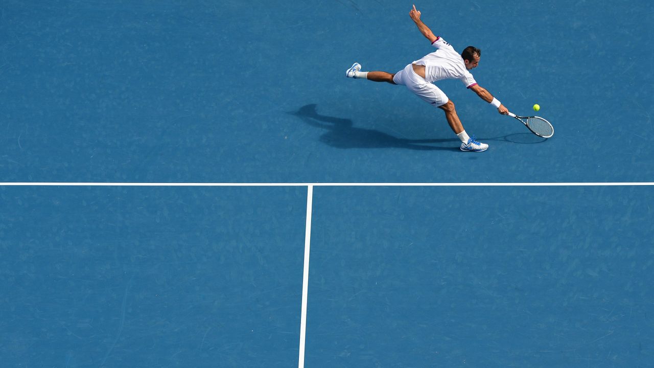 Stepanek hits a return against Djokovic during their men's singles match on January 18.