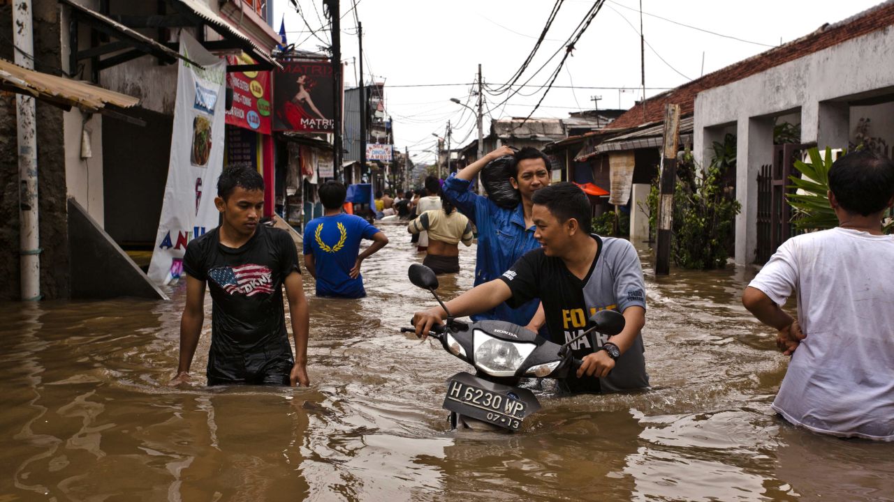 People wade through floodwaters in Central Jakarta district on January 18, 2013 in Jakarta, Indonesia.