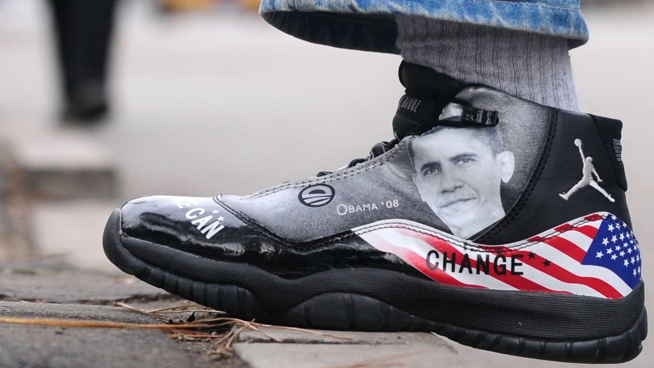 CHINA: A man wears a basketball sneaker with an image of Obama on November 11, 2009, along a street in Beijing.