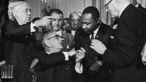 Conservatives say MLK's primary goal was to change hearts, not law. Here King shakes hands with President Lyndon Johnson after the signing of the 1964 Civil Rights Act. 