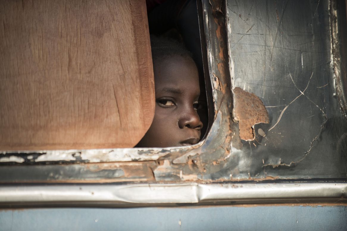 A Malian child looks out from a bus as Malian army soldiers check vehicles and passengers in the city of Niono on Friday, January 18. Malian troops, with help from France and a U.N.-mandated African force, are fighting al Qaeda-linked Islamist militants.