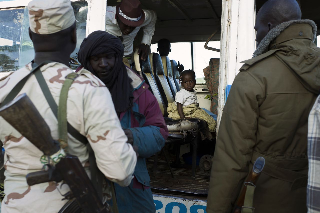 Malian soldiers man a checkpoint in Niono on January 18.