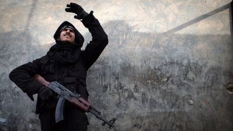 A Syrian rebel fighter tries to locate a government jet fighter in Aleppo on January 18. 