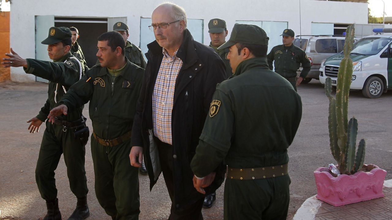 Freed Norwegian hostage Oddvar Birkedal is escorted at a police station in Amenas, Algeria, on Saturday.  