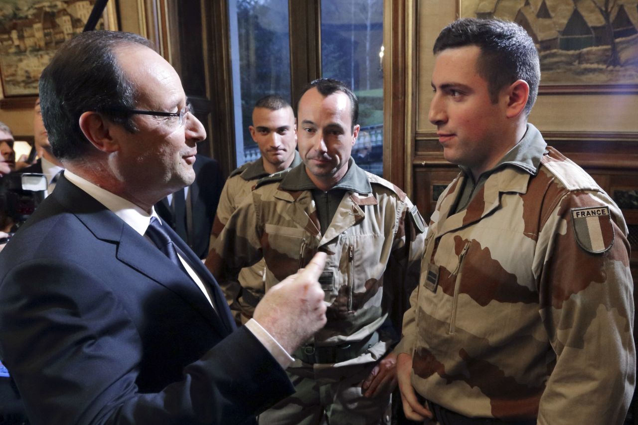 French President Francois Hollande, left, speaks with soldiers who are due to leave for Mali, during a meeting in Tulle, France, on January 19.