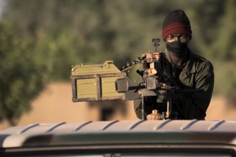 A Malian soldier holds a machine gun on top of a jeep on the road back from the town of Mopti, Mali, on Saturday, January 19. 