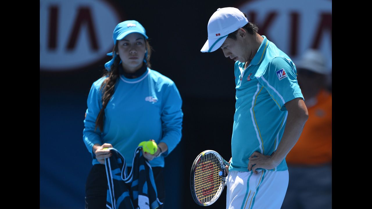 Nishikori reacts during his match against Ferrer on January 20 as a ballgirl watches.