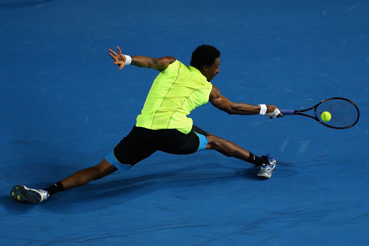 Gael Monfils of France twists around to return the ball in his third-round match against compatriot Gilles Simon on Saturday, January 19. Simon defeated Monfils 6-4, 6-4, 4-6, 1-6, 8-6.