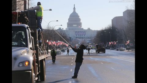 Workers prepare the parade route in front of the U.S. Capitol building on Sunday.