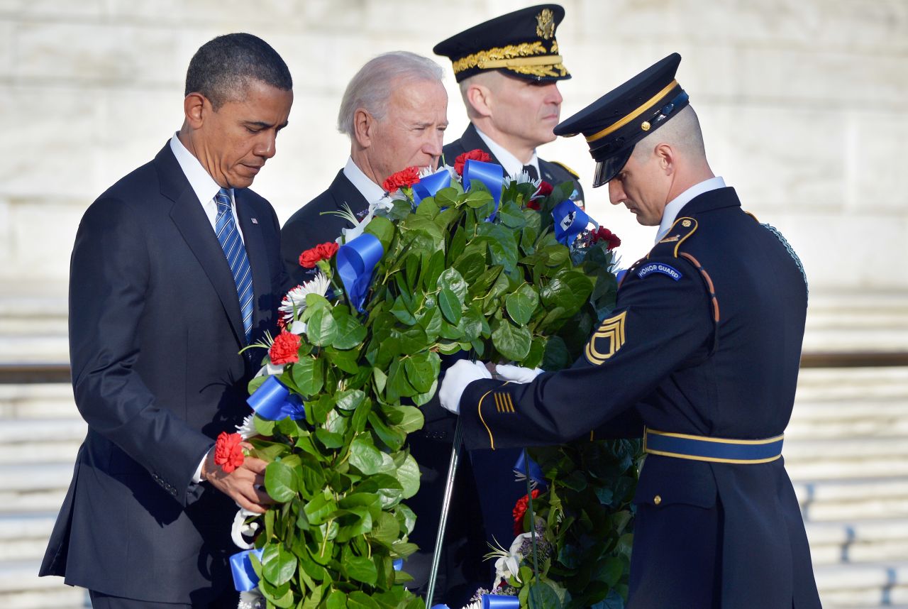 Obama and Biden lay a wreath at the Tomb of the Unknowns at Arlington National Cemetery in Arlington, Virginia, on January 20.