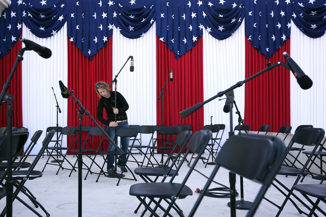 A stage technician from Maryland Sound International sets up microphones for the presidential inauguration at the West Front of the U.S. Capitol on Sunday. 