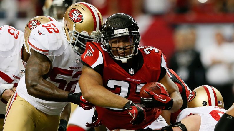 Michael Turner of the Atlanta Falcons carries the ball as he is hit by No. 52 Patrick Willis of the San Francisco 49ers on Sunday.