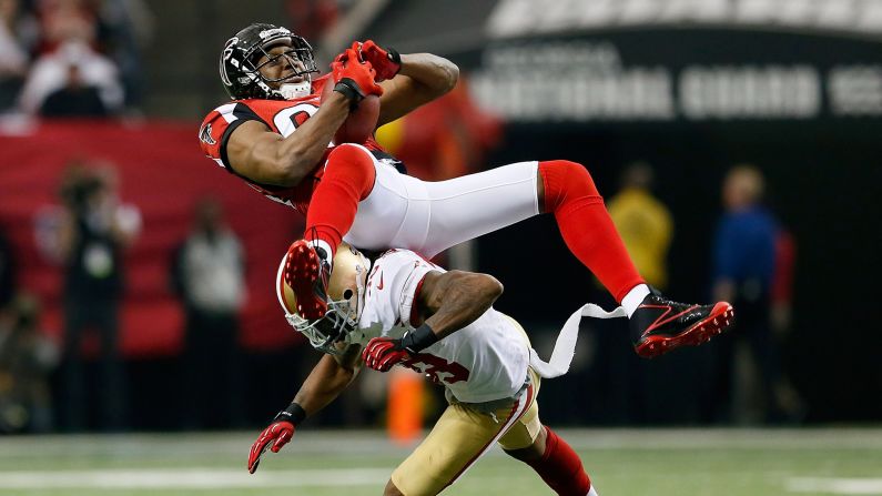 Roddy White of the Atlanta Falcons catches a pass as he is hit by Dashon Goldson of the San Francisco 49ers.