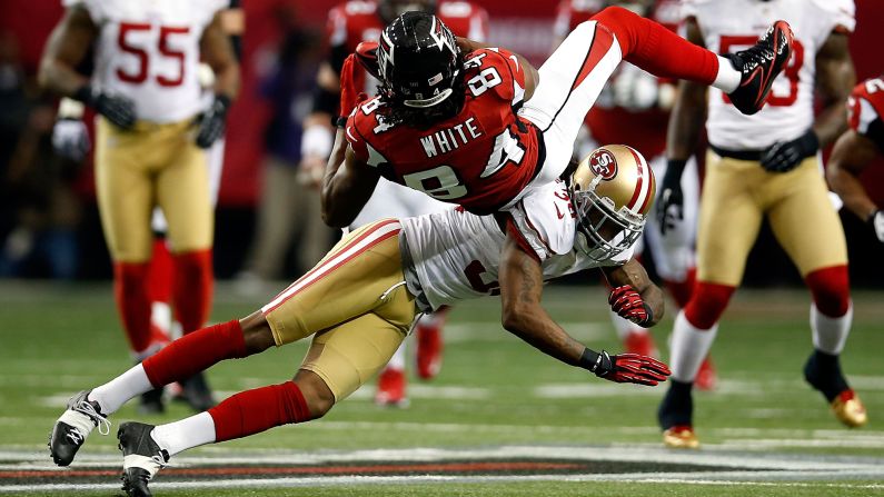 Dashon Goldson of the 49ers hits Falcons receiver Roddy White on Sunday.