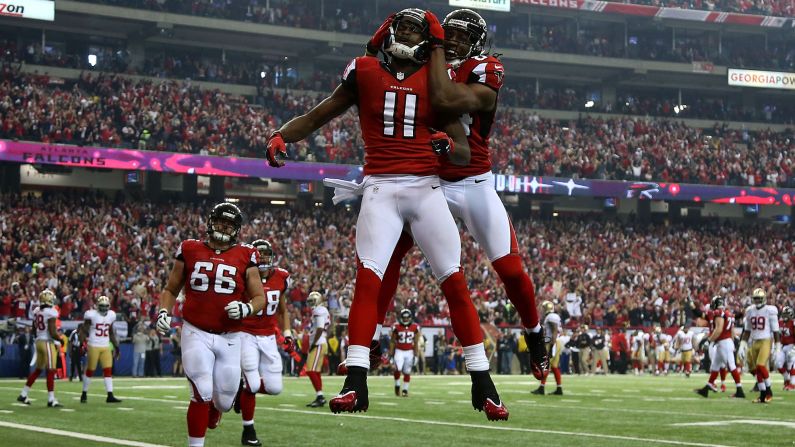 Julio Jones, left, and Roddy White of the Atlanta Falcons jump in the air to celebrate after Jones caught a 20-yard touchdown in the second quarter.