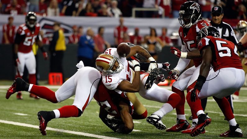 Michael Crabtree of the San Francisco 49ers fumbles the football against the Atlanta Falcons. The ball was recovered by No. 54 Stephen Nicholas of the Falcons on the Atlanta 1 yard line.