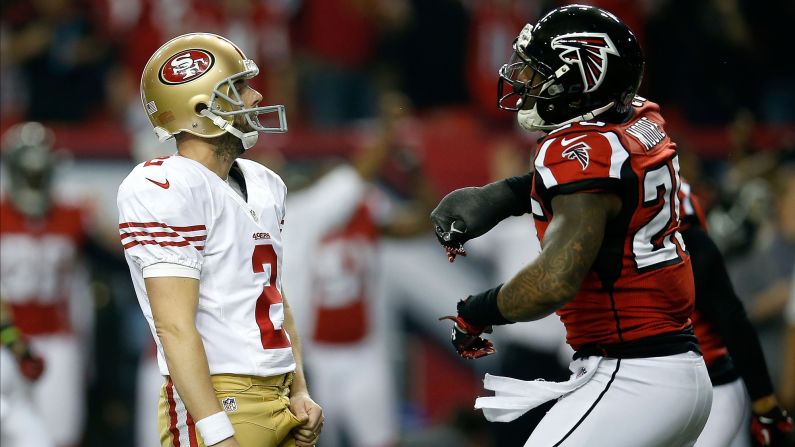 Kicker David Akers of the San Francisco 49ers looks on after missing a 38-yard field goal as William Moore of the Atlanta Falcons cheers.