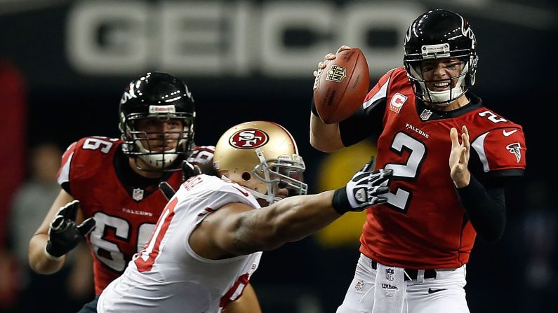 Falcons quarterback Matt Ryan holds onto the ball as he is tackled by Isaac Sopoaga of the San Francisco 49ers.
