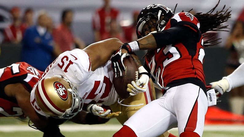 Dunta Robinson of the Falcons forces Michael Crabtree of the 49ers to fumble.