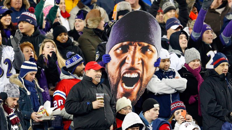 A Baltimore Ravens fan holds up a giant photo of linebacker Ray Lewis' face.