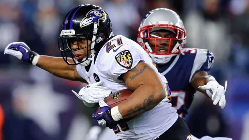 Ray Rice of the Ravens runs the ball against Devin McCourty of the Patriots.