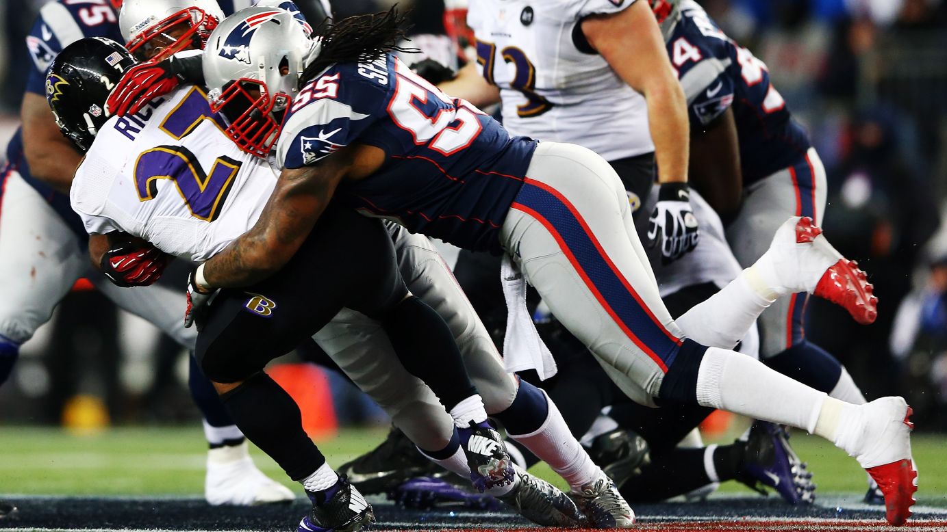 Brandon Spikes of the New England Patriots tackles Ray Rice of the Baltimore Ravens.