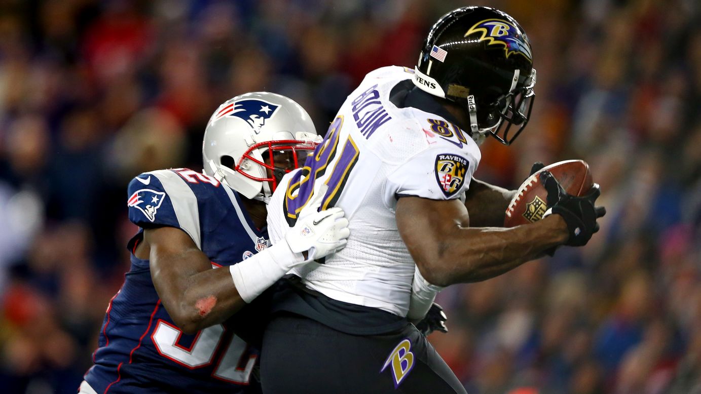 Ravens wide receiver Anquan Boldin scores a touchdown against Devin McCourty of the Patriots.