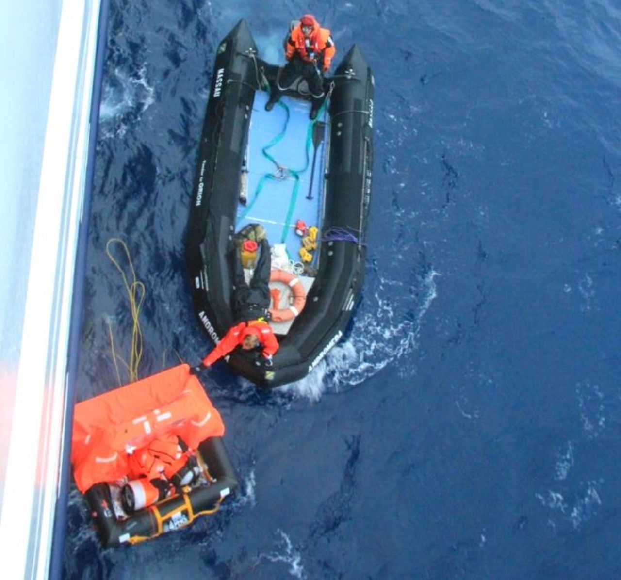A rescue boat from cruise ship Orion reaches Alain Delord's life raft  on Sunday.