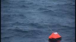 Alain Delord's life raft is pictured adrift in seas south of Australia and shortly before his rescue by the cruise ship Orion